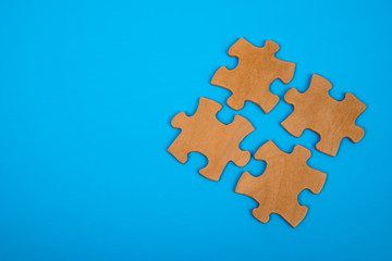 The puzzle pieces are merged into a single unit. on a blue background. Concept business idea, solution, teamwork, cooperation, partnership