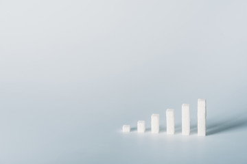 white sugar cubes arranged in stacks on grey background with copy space