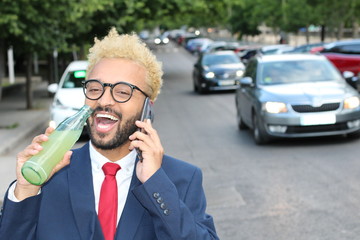 Afro hip businessman talking on the phone outdoors 