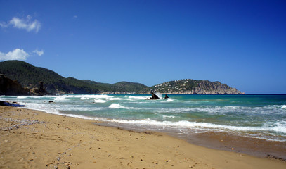 Waves on the beach Es Figueral. Ibiza Island Spain.