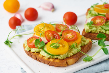 avocado toast with cherry tomatoes and herbs, breakfast, closeup