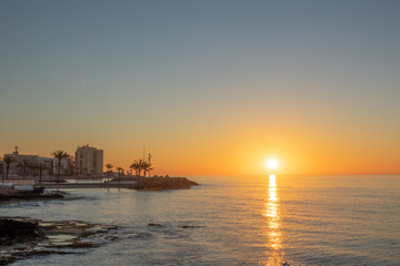 Beach and rocks of Torrevieja center during sunrise