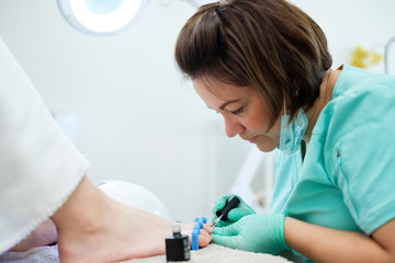 Woman having pedicure at beauty salon