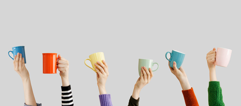 Many Different Arms Raised Up Holding Coffee Cup