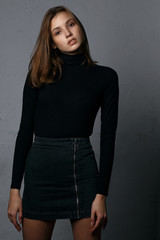Test shooting for pretty young model wearing denim skirt and black sweater