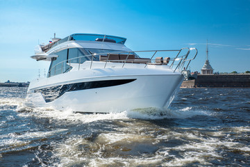 white yacht at river in city, luxury lyfe