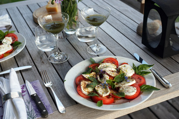 Tasty tomato mocarella cheese caprese salad, healthy vegetable food on wooden table