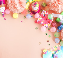 Party background top view.  Festive , birthday multicolored decorations on coral color background . Flat lay style. Copy space