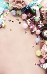 Party background top view toned.  Festive , birthday multicolored decorations on coral color background . Flat lay style. Copy space