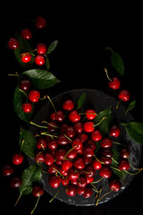 Sweet cherry. Sweet cherry on a dark background. Sweet cherry lies on the table. Drops of water on the cherry.