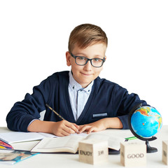 a boy with glasses doing a lesson in class doing an assignment, back to school, schoolboy with a backpack at school, school uniform