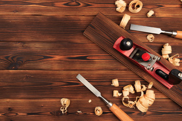 chisels plane and sawdust on a wooden table.