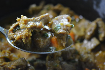 Cooking, tasty stewed meat of a cow with curry, onions and sliced carrots. Great food, healthy food, life and beauty.