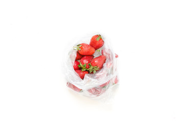 Red ripe strawberries in plastic package on white background. - Image