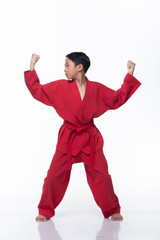 Master Red Belt Kid TaeKwonDo show basic step of fighting pose, Asian Teenager boy black hair tanned skin exercise warm up in red uniform bare foots, studio lighting white background copy space
