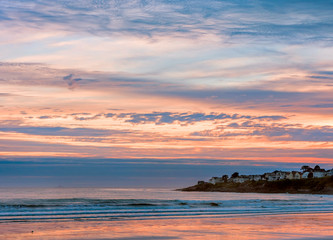 Early  morning on the Atlantic coast. Reflection of the dawn sky in the water on the sand. USA. Maine.