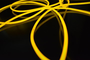 The original yellow lighting of thick electoluminescent wires and lines. Graphic abstract light...