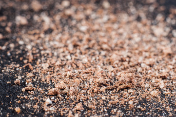 Finely ground cinnamon powder, on a dark background. Macro shooting.