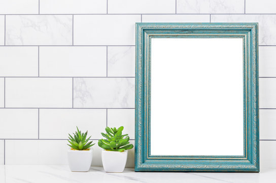 Blank blue vintage photo frame with cactus.