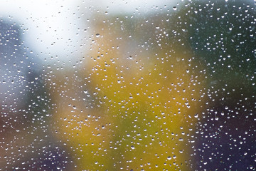 Drops of rain on the window during the rain in the fall_