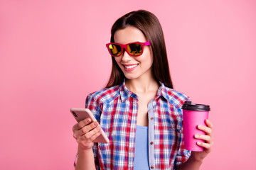 Portrait o modern attractive stylish lady hold hand have free time device communicate friends type search notification use user wear bright specs wear trendy checked shirt isolated pink background