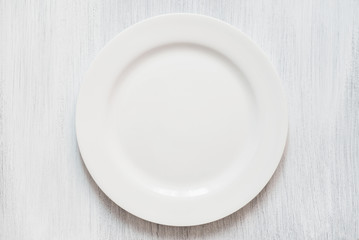 White round plate on white background. Empty white plate on white background.
