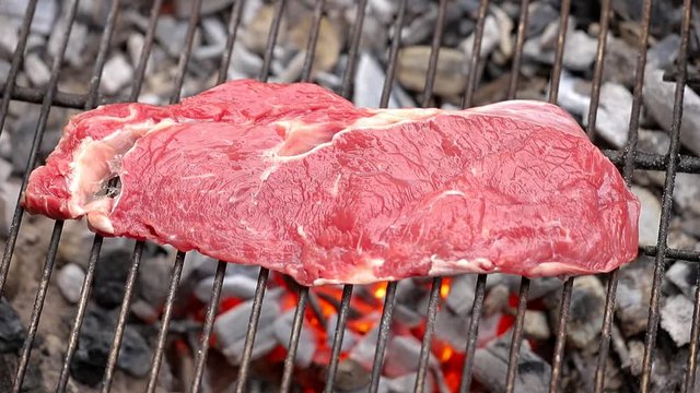 grilling a steak on a bbq 