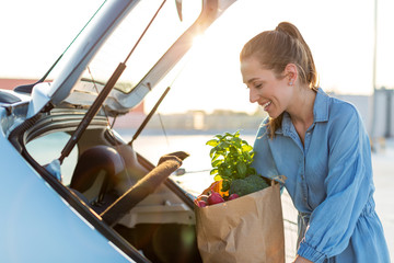 Happy girl packing groceries