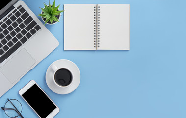 Business concept. Clean bright light blue office table desk, minimal style with laptop coffee and smart phone, copy space, top view, flat lay, mockup