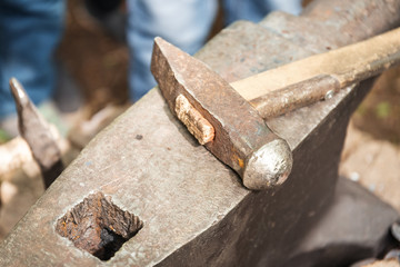 Anvil and blacksmith hammer, closeup