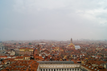 Fototapeta na wymiar Beautiful aerial view of the red rooftops in an Italian city during a foggy day