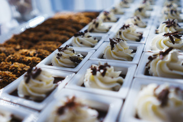 Sweet desserts, pastries on the table during the event. Catering servicing of guests and participants during mass events.