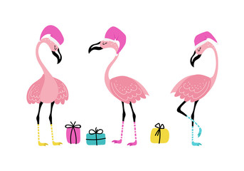Obraz premium Three flamingos with Santa hats