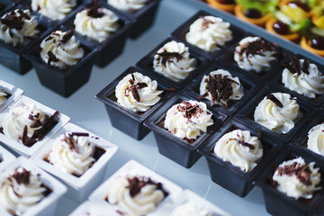 Sweet desserts, pastries on the table during the event. Catering servicing of guests and participants during mass events.