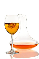 Amber wine. Wine in a glass and decanter. Traditional Georgian wine according to ancient technology. Isolated on white background. Close up and vertical orientation.