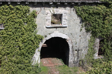 Fort Bastione, a nineteenth-century military fortress, abandoned to the neglect of nature. distressing stone construction inside and out. wild nature covers the whole castle