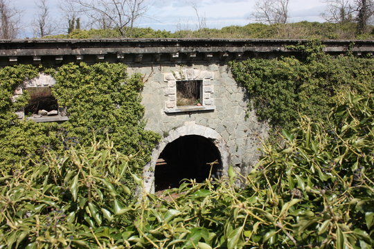 Fort Bastione, a nineteenth-century military fortress, abandoned to the neglect of nature. distressing stone construction inside and out. wild nature covers the whole castle