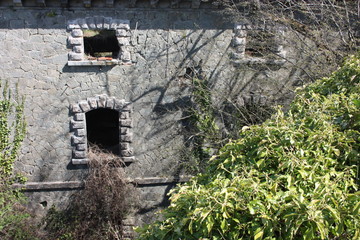 Fort Bastione, a nineteenth-century military fortress, abandoned to the neglect of nature. distressing stone construction inside and out. wild nature covers the whole castle