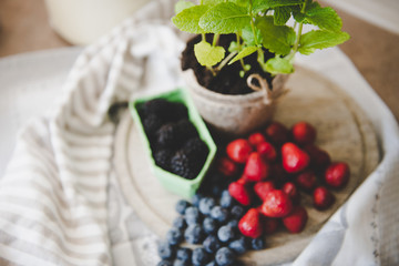 fresh strawberry blueberry and blackberry on wooden desk