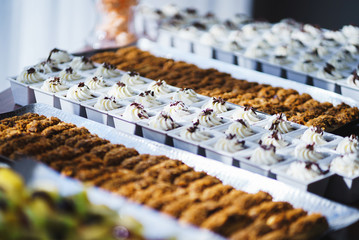 Sweet desserts, pastries on the table during the event. Catering servicing of guests and participants during mass events.