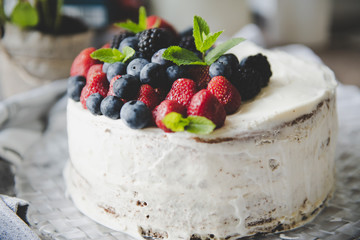 beautiful white cream cheese cake with different summer berries