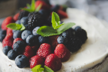 beautiful white cream cheese cake with different summer berries