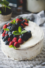 beautiful white cream cheese cake with different summer berries