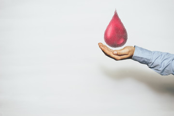 Human hand blood drop.  World Blood Donor Day. Mixed media.