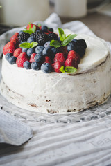 beautiful white cream cheese cake with different summer berries