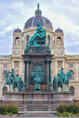 Fototapeta na wymiar Sculptures of queen and horses with dome museum background in Vienna Austria with blue sky