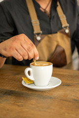 Man doing and taking coffee from espresso machine