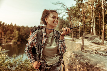 Joyful nice woman listening to the walkie talkie
