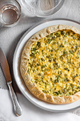 Tart with eggs and green onions on a plate
