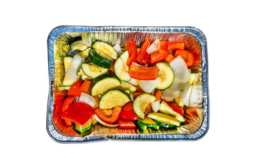 Aluminum tray with vegetables, isolated on a white background with a clipping path.
